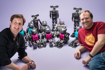 Mason researchers Dan Lofaro and Sean Luke pose for a team picture with Mason's Robot World Cup Team