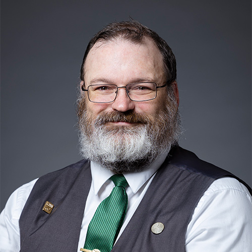 Kevin Andrea wears a green tie and gray vest