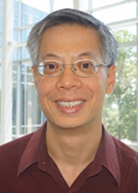 Mason Professor Brian Mark wears a red shirt and glasses and has gray hair in his faculty profile