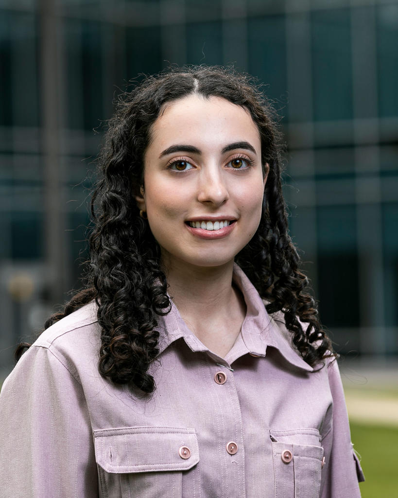 Mason student Lina Alkarmi wears a lavendar shirt and has dark hair in this photo