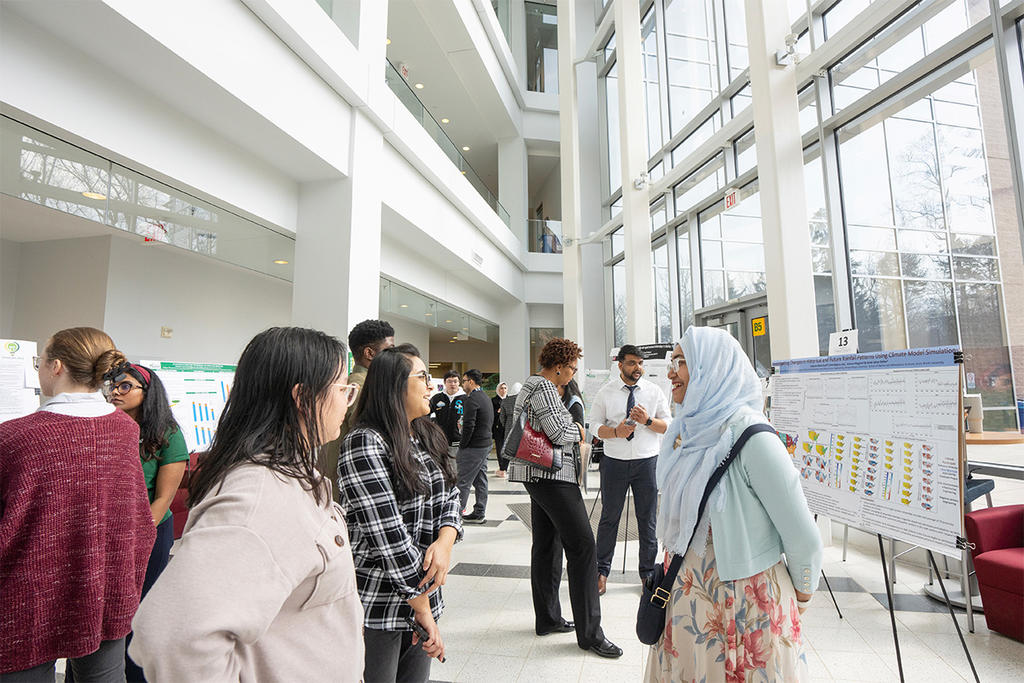 A young muslim woman wearing a hijab presents her abstract at Innovation Week