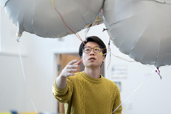 Daigo Shishika with a silver mylar film balloon during flight testing.