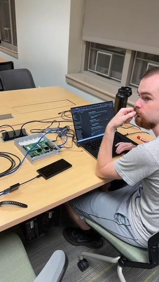 Club member Ryan Murphy working on routers. Photo provided.