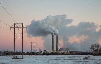 A coal-fired power plant emits pollutants into the air