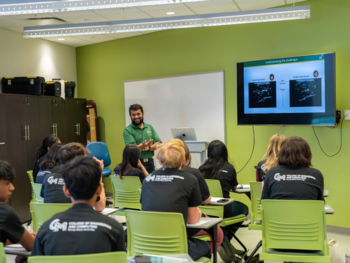 Professor with students in classroom