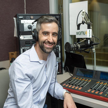 Jeffrey Moran sits in front of the WGMU microphone