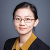 GMU faculty member Pei Dong wears a yellow blouse and dark cardigan