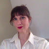 A well-styled Nora McDonald in a white shirt and red lipstick